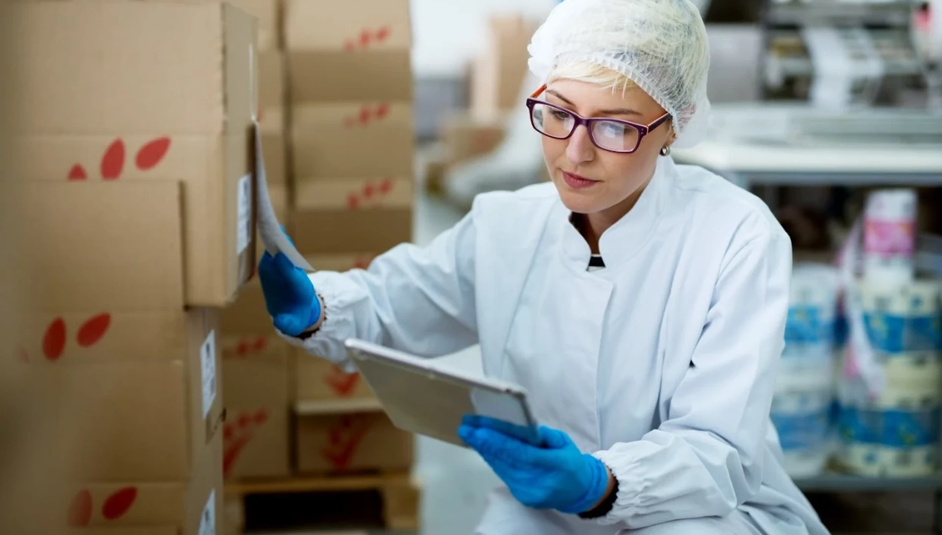 Employee checking inventory with tablet